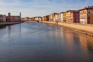 Fototapeta na wymiar View along the embankment of Arno river in historic part of Pisa, Italy