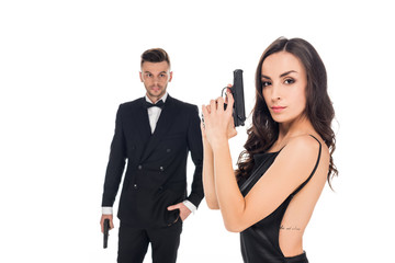 couple of secret agents in black clothes posing with guns, isolated on white