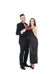 beautiful smiling couple holding love sign on valentines day, isolated on white