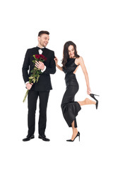 beautiful couple in black clothes posing with red roses on valentines day, isolated on white