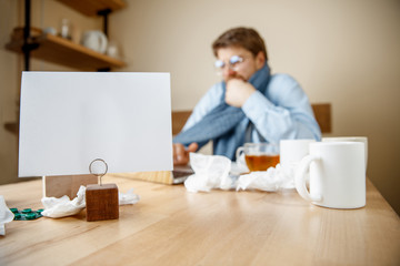 Sick man with pills working in office, businessman caught cold, seasonal flu. Pandemic influenza, disease prevention, illness, virus, infection, temperature, fever and flu concept