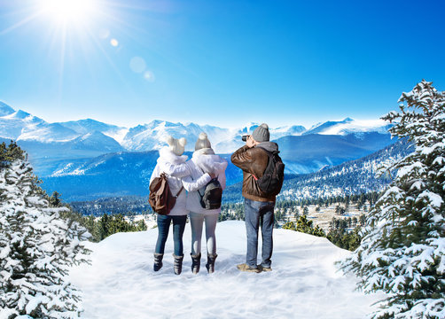 Family Enjoying Beautiful  Mountain View On Winter  Hiking Trip. People On Winter Vacation. Rocky Mountain National Park. Close To Estes Park, Colorado, USA