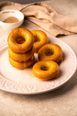 homemade donuts on a white plate, dark background