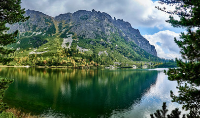 Fototapeta na wymiar Beautiful panoramic view of Popradske pleso (once called Rybie pleso) is a mountain lake of glacial origin located in the High Tatras, Slovakia. It is situated right on the path of Tatranska magistral