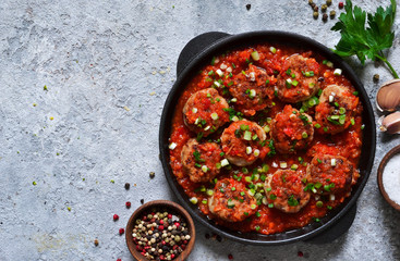 Meat balls in tomato sauce with spices concrete background. View from above.
