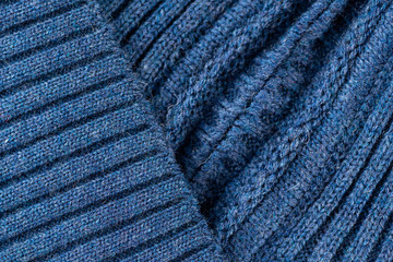 Blue knitted fabric macro seam blurred background