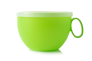 Green plastic cup on a white background