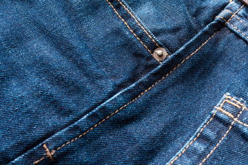 Fototapeta premium Blue jeans fabric macro seam pattern blurred background