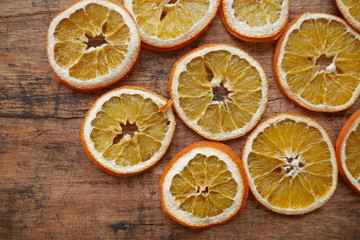 Fototapeta na wymiar Dry orange slices on wooden background