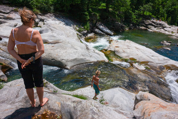 Some tourists in the spectacular Toce degli Orridi di Uriezzo gorges in Piedmont, Italy.