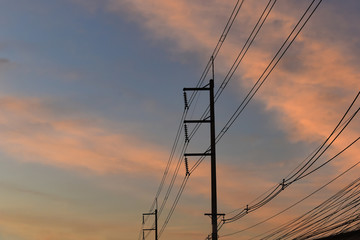 pylon electricity power line with sunset sky background