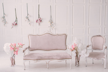 White room with vintage interior and spring flowers
