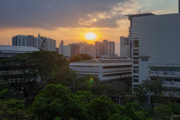 Sunset behind the building in the town Bangkok, Thailand.
