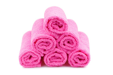 Obraz na płótnie Canvas Stack of pink towels, isolated on white background