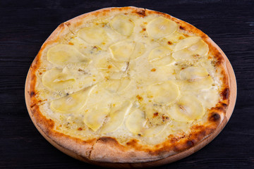 Pizza sweet with different grades of cheese and pear