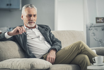 Man in grey jacket feeling thoughtful