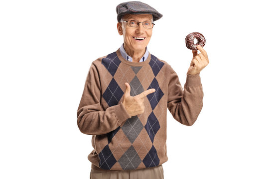 Cheerful senior man holding a chocolate donut and pointing at it