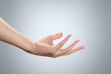 Palm up hand gesture, asking, holding or taking something on gray background