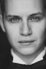Obraz premium Close-up portrait of Handsome young brunette model. Looking at the camera, expressive look, black and white photo
