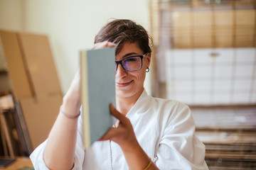 Young adult woman making a notebook in his laboratory - obrazy, fototapety, plakaty