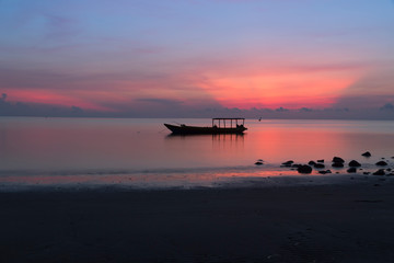 Fototapeta na wymiar Silhouette of fisherman boat at Atauro Island, Timor Leste during sunrise