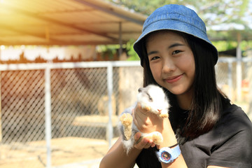 Asian teenagers go on a farm trip And carrying a small rabbit