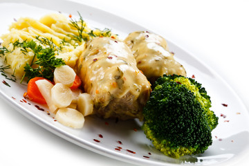 Roast meatballs with mashed potatoes and broccoli on white background