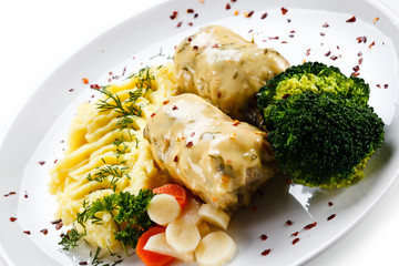 Roast meatballs with mashed potatoes and broccoli on white background