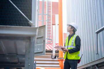 Asian Maintenance engineer at the waste water management system of a huge factory,maintenance checking technical data of heating system equipment,Thailand people