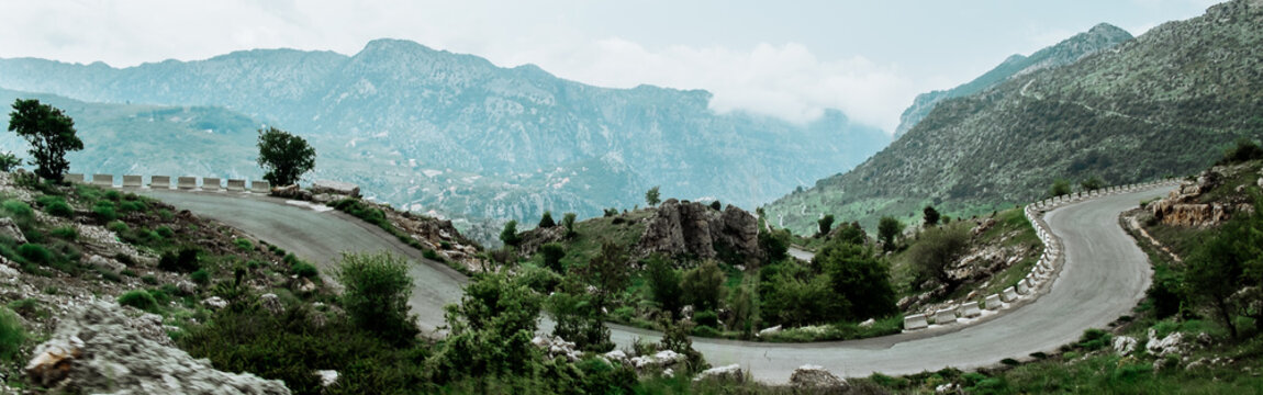 Landscape in spring in Lebanon : straight road heading to cliff and summits in Mount Lebanon,