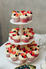 beautiful big three-story cherry-colored wedding cake one