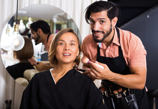 Cheerful Male Makeup Artist Applying Cosmetics