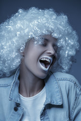 Portrait of a young girl in a white wig. Creative toning.