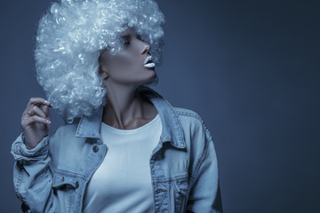Portrait of a young girl in a white wig. Creative toning.