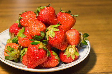 Strawberries in ceramic bowl. Fresh nice strawberries on wooden table. Juice strawberry - Image
