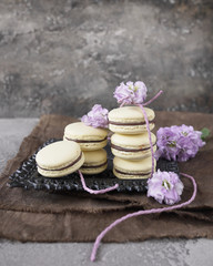 Obraz na płótnie Canvas Yellow cake Macarons with chocolate filling
