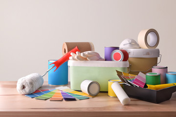 Table with painting tools for home white wall background