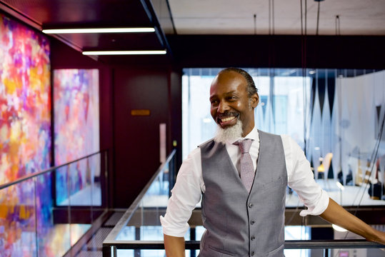 Senior black businessman laughing in a contemporary office - Powered by Adobe