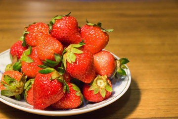 Strawberries in ceramic bowl. Fresh nice strawberries on wooden table. Juice strawberry - Image