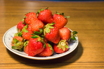 Strawberries in ceramic bowl. Fresh nice strawberries on wooden table. Juice strawberry - Image