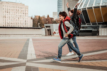 Joyful children happily running through the square © Viacheslav Yakobchuk
