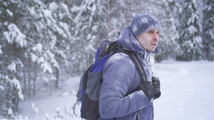 Fototapeta na wymiar Portrait frozen man covered with snow in the winter forest