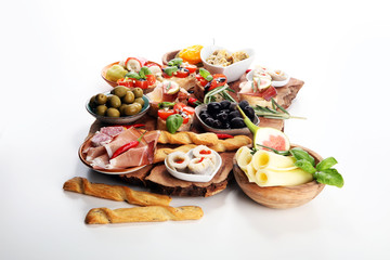 Italian antipasti wine snacks set. Cheese variety, Mediterranean olives, pickles, Prosciutto di Parma, tomatoes, artichokes