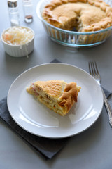 Slice of homemade sauerkraut pie on gray wooden table. Cabbage cake tradition russian food