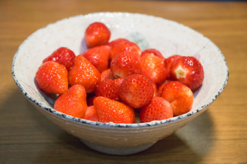 Strawberries in ceramic bowl. Fresh nice strawberries on wooden table. Juice strawberry - Image
