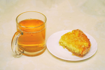 Piece of cake on a saucer and Cup of tea