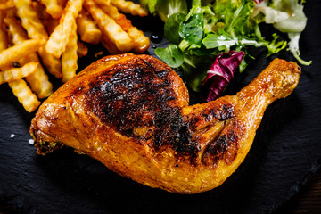 Grilled chicken leg with french fries and vegetables