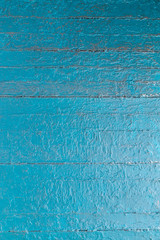Fototapeta na wymiar Grungy multi layered peeling paint on wooden planks background or texture in blue.