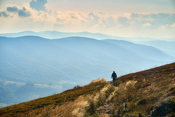 Freedom, man spreads his hands on the Sunset. Beautiful panoramic view of the Bieszczady mountains in the early autumn, Bieszczady National Park (Polish: Bieszczadzki Park Narodowy), Poland.