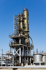 Oil refinery in Russia. equipment and complexes for hydrocarbon processing. Section of technological columns for the manufacture of gasoline, pipelines, tank.
